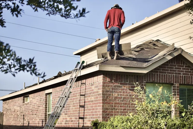 Professional roofer working on a residential roof in Freneau